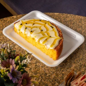 Meio bolo de pamonha, milho verde com coco com cobertura de maracujá